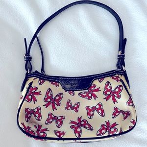 Dooney & Bourke retired white Minnie bows pouchette released in 2011. Used.